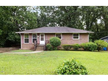 Charming brick home featuring a well-maintained lawn and inviting front entrance at 1219 Lakeland St, Durham, NC 27701
