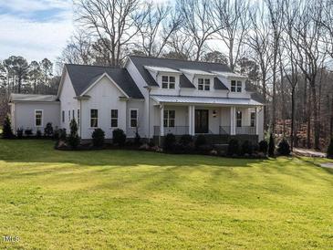 Charming two-story home with a covered porch and well-manicured lawn at 1680 Terry Road, Durham, NC 27712