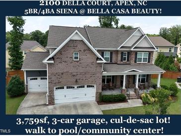 Charming brick-front home featuring a three-car garage and covered front porch in a desirable neighborhood at 2100 Della Ct, Apex, NC 27502
