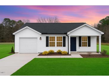 Charming single-story home with a well-manicured lawn, attached garage and welcoming entrance at 261 Johnson Ridge Way, Four Oaks, NC 27524