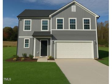 Charming two-story home featuring a two-car garage and manicured lawn at 296 Johnson Ridge Way, Four Oaks, NC 27524