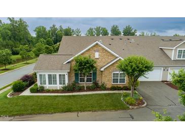 Attractive condo with stone front, lush landscaping and an attached garage at 425 Faith Dr, Gibsonville, NC 27249