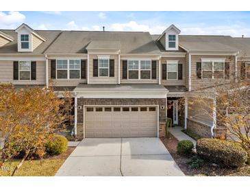 Charming townhome featuring a two-car garage and beautiful exterior finishes at 635 Grace Hodge Dr, Cary, NC 27519