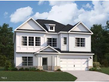 Charming two-story home with white siding, a two-car garage, and professional landscaping at 127 S Harvest Ridge Way # Homesite 321, Wilson's Mills, NC 27520