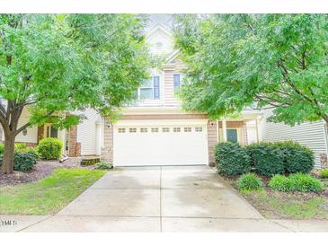 Charming two-story home featuring a two-car garage and manicured front yard with mature trees at 145 Torrey Heights Ln, Durham, NC 27703