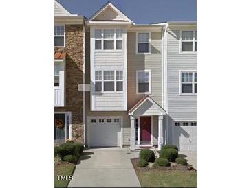 Charming townhome featuring an attached one-car garage, private entrance, and neutral exterior paint scheme at 1527 Haywards Heath Ln, Apex, NC 27502