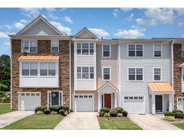 Three-story townhomes with varied facades, attached garages, and manicured front lawns create a welcoming curb appeal at 1527 Haywards Heath Ln, Apex, NC 27502