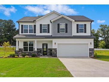 Charming two-story home with a manicured lawn and a two-car garage, perfect for a Gathering at 55 Fern Ridge Dr, Cameron, NC 28326