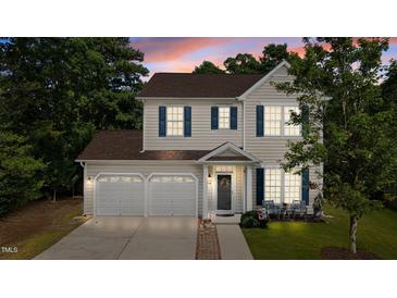 Charming two-story home with a well-manicured lawn, lovely landscaping, and a two-car garage at 648 Long Melford Dr, Rolesville, NC 27571