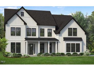 Charming two-story home features a covered entry, black framed windows, and a beautifully landscaped front yard at 805 Timber Mist Ct, Cary, NC 27519
