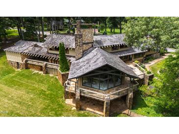 Stunning home with stone and wood exterior, a unique design, and a spacious outdoor deck at 812 Kenmore Rd, Chapel Hill, NC 27514