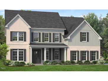 Charming two-story home with a beautifully landscaped yard and a welcoming front porch at 812 Timber Mist Ct, Cary, NC 27519