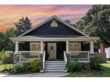 Charming home featuring a covered front porch and landscaped yard, perfect for enjoying the outdoors at 109 St Marys St, Garner, NC 27529