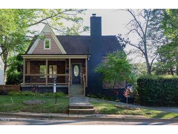 Charming two-story home with a covered porch and a well-manicured lawn at 119 W Vernon Ave, Wake Forest, NC 27587