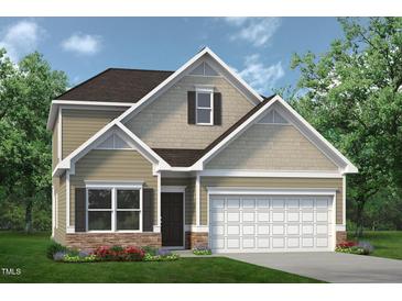 Charming two-story home with stone accents, well-maintained landscaping, and an attached two-car garage at 157 Mildred Pl, Broadway, NC 27505