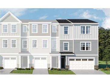 Charming new construction townhome showcasing a beautifully designed facade with a welcoming entrance and attached garage at 215 Carova Bnd, Apex, NC 27539