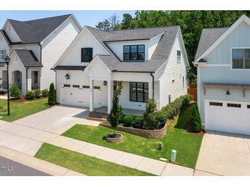 Charming two-story home with manicured lawn, and a two car garage at 245 Tumbling River Dr, Wendell, NC 27591