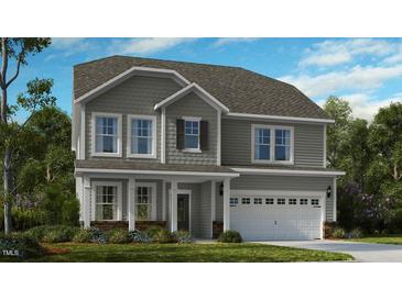 Charming two-story home featuring gray siding, a two-car garage, and a well-maintained front lawn at 527 Claftin St, Sanford, NC 27330