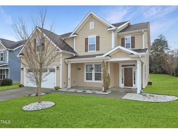 Charming two-story home with a well-manicured lawn and a two-car garage at 800 Tree Green Ln, Wake Forest, NC 27587