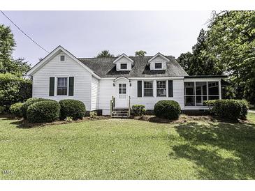 Charming two-story home with green lawn, bushes, and white picket fence at 931 Eastern Ave, Nashville, NC 27856