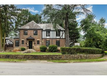 Charming brick two-story home with Tudor accents and manicured front yard in a desirable location at 1541 Caswell St, Raleigh, NC 27608