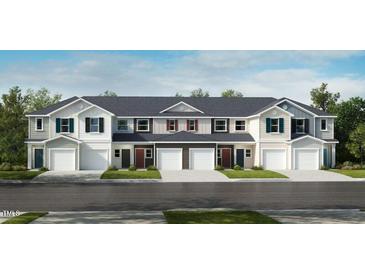 Charming townhome featuring a landscaped front yard and convenient garage entry at 2009 Rabbitbrush St, Durham, NC 27704