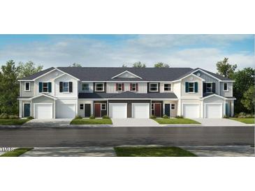 New townhome construction with diverse color schemes, garages, and manicured lawns at 2013 Rabbitbrush St, Durham, NC 27704