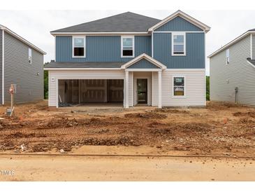 New construction two-story home features a two-car garage and blue vinyl siding at 2254 Cherry Creek Rd, Haw River, NC 27258