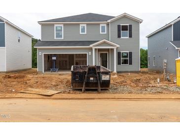 New two-story home with gray siding, an attached garage, and front yard under construction at 2258 Cherry Creek Rd, Haw River, NC 27258