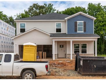 New two-story home with a two-car garage, blue and gray siding, and construction in progress at 2291 Cherry Creek Rd, Haw River, NC 27258