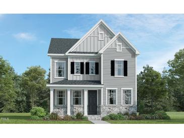 Charming two-story home showcasing a stone foundation and gray siding, complete with a welcoming front porch at 316 Calvander Ln, Apex, NC 27539