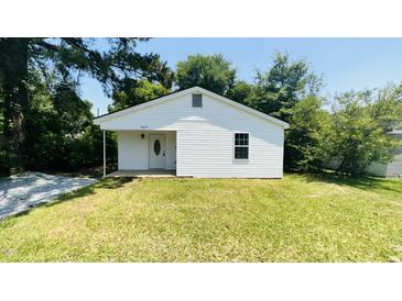 Charming single-story home with white siding, manicured lawn, and mature trees at 505 E Canary St, Dunn, NC 28334