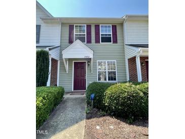Charming townhouse featuring a stylish front door with a covered entryway and well-maintained landscaping at 7832 Averette Field Dr, Raleigh, NC 27616