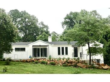 Charming single-story home with modern updates and beautifully landscaped front yard at 100 Eastwood Lake Rd Rd, Chapel Hill, NC 27514