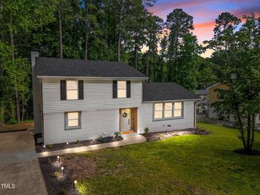 Charming two-story home featuring manicured lawn, updated windows and neutral paint colors at 1143 Sturdivant Dr, Cary, NC 27511