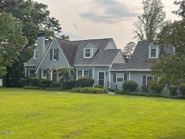 Charming home featuring a large lawn, a classic roof, and mature trees at 11609 Us 401, Fuquay Varina, NC 27526
