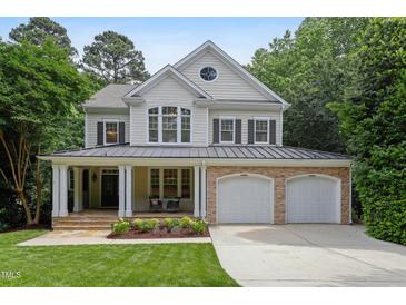 Charming two-story home with a welcoming front porch and a well-manicured lawn at 118 Killingsworth Dr, Cary, NC 27518