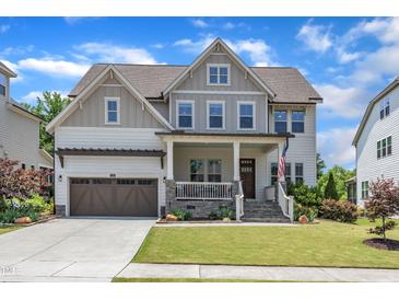 Charming two-story home featuring manicured lawn, wood accents, and an attached two-car garage at 1716 Aberdour Dr, Apex, NC 27502