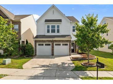 Charming two-story home features a two-car garage and well-maintained landscaping at 2036 October Dr, Durham, NC 27703