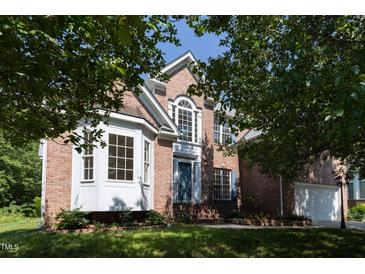 Charming brick home with a well-manicured lawn and mature trees at 227 Shalimar Dr, Durham, NC 27713
