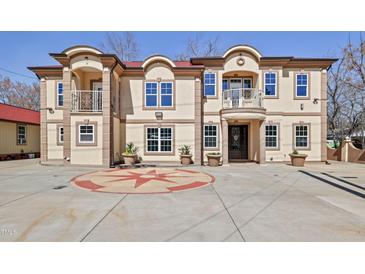 Stunning multi-Gathering home featuring a grand facade, balconies, and manicured landscaping for sophisticated curb appeal at 318 W Lillington St, Angier, NC 27501