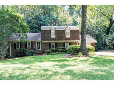 Charming two-story brick home with a well-manicured lawn and lush landscaping at 5304 Cypress Ln, Raleigh, NC 27609