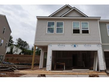 New two-story home exterior with light gray siding and a spacious two-car garage at 7106 Hubner Pl # 44, Cary, NC 27519