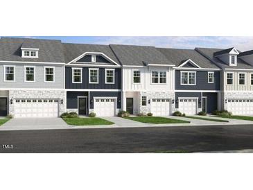 View of newly constructed townhomes featuring a mix of colors and single-car garages at 8763 Wardle Ct, Wake Forest, NC 27587