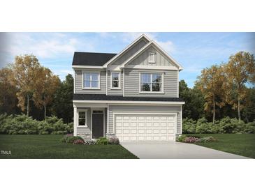 Charming two-story home features a pristine lawn and a two-car garage at 1007 Red Roses Ave, Durham, NC 27703