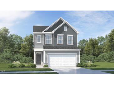 Beautiful two-story home featuring attached two-car garage and professionally landscaped yard at 1009 Red Roses Ave, Durham, NC 27703