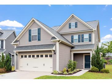Charming two-story home with gray siding, blue shutters, manicured lawn, and an attached two-car garage at 108 White Burley Ct, Durham, NC 27703
