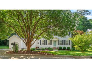 Charming white two-story home with black shutters and a well-manicured front yard landscape at 110 Benedum Pl, Cary, NC 27518