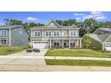 Charming two-story home with a well-manicured lawn and attached two car garage at 1100 Balsawood Dr # 5, Durham, NC 27705