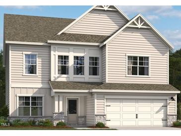 Charming two-story home with light siding, a welcoming entrance, and an attached two-car garage at 1501 Erastus Ct, Fuquay Varina, NC 27526